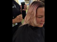 A precise cross beneath a lifted crown braid—faith forward, beautifully worn.