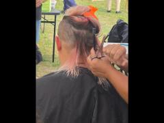 A precise cross beneath a lifted crown braid—faith forward, beautifully worn.