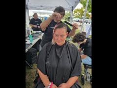 A precise cross beneath a lifted crown braid—faith forward, beautifully worn.