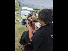 A precise cross beneath a lifted crown braid—faith forward, beautifully worn.