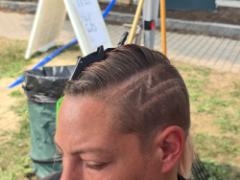 A precise cross beneath a lifted crown braid—faith forward, beautifully worn.