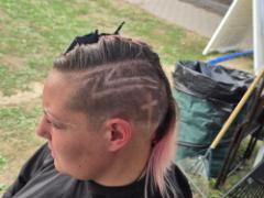 A precise cross beneath a lifted crown braid—faith forward, beautifully worn.