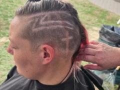 A precise cross beneath a lifted crown braid—faith forward, beautifully worn.