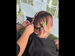 A precise cross beneath a lifted crown braid—faith forward, beautifully worn.