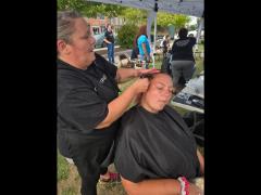 A precise cross beneath a lifted crown braid—faith forward, beautifully worn.