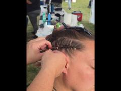 A precise cross beneath a lifted crown braid—faith forward, beautifully worn.