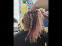 A precise cross beneath a lifted crown braid—faith forward, beautifully worn.