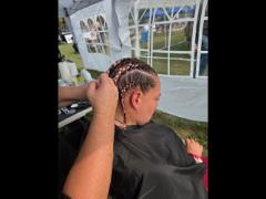 A precise cross beneath a lifted crown braid—faith forward, beautifully worn.