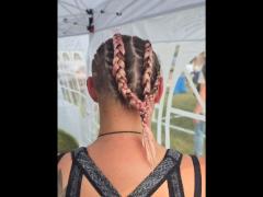 A precise cross beneath a lifted crown braid—faith forward, beautifully worn.