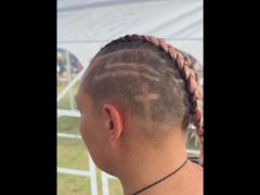 A precise cross beneath a lifted crown braid—faith forward, beautifully worn.