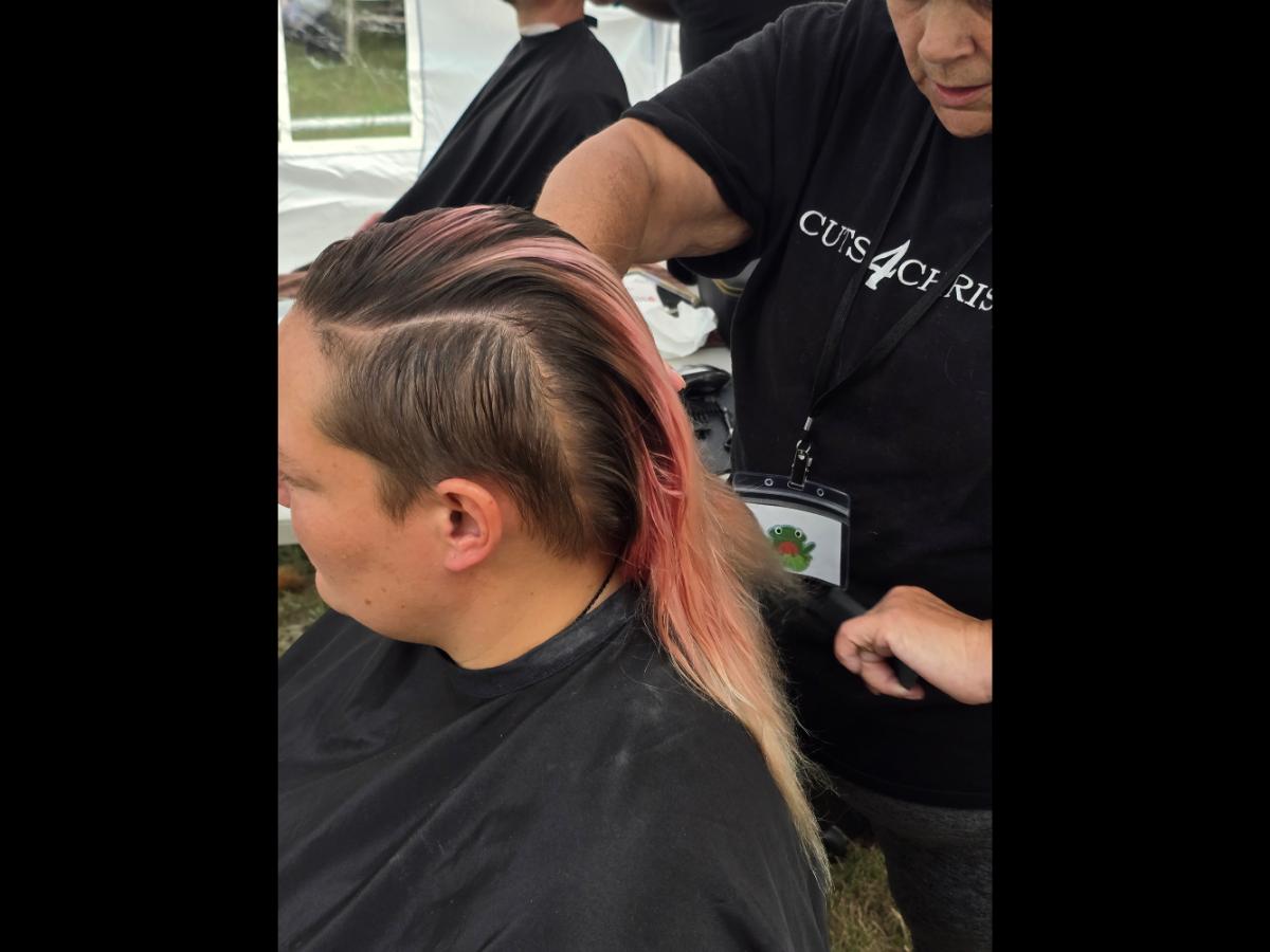 A precise cross beneath a lifted crown braid—faith forward, beautifully worn.