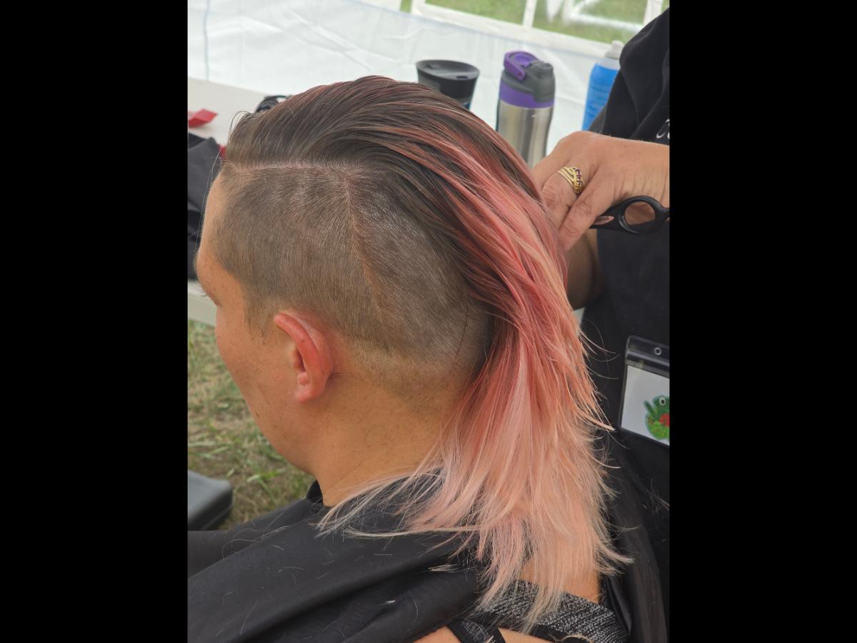 A precise cross beneath a lifted crown braid—faith forward, beautifully worn.