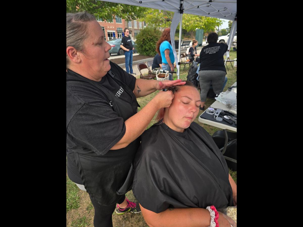 A precise cross beneath a lifted crown braid—faith forward, beautifully worn.