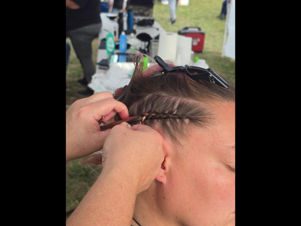 A precise cross beneath a lifted crown braid—faith forward, beautifully worn.