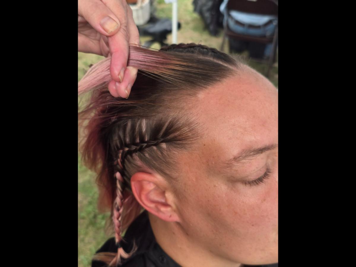 A precise cross beneath a lifted crown braid—faith forward, beautifully worn.