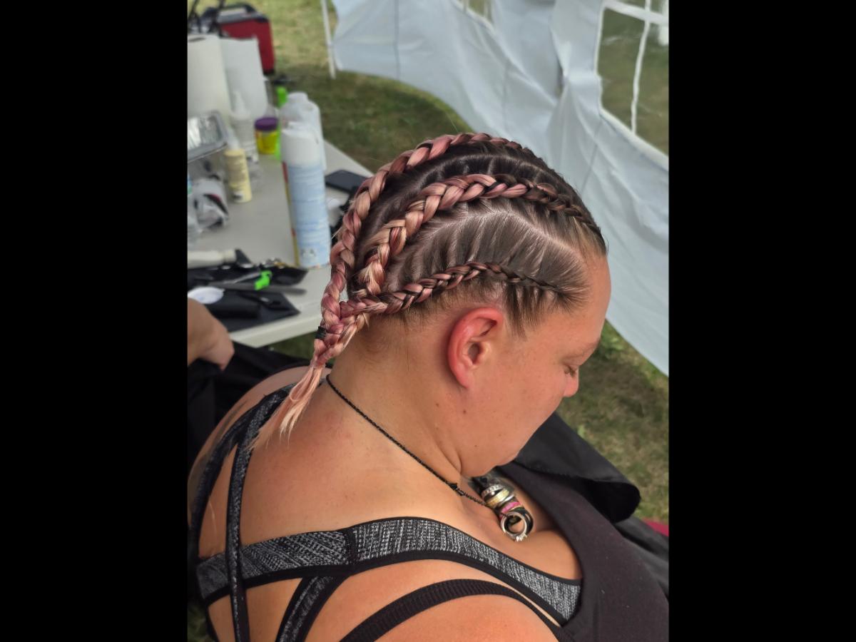 A precise cross beneath a lifted crown braid—faith forward, beautifully worn.