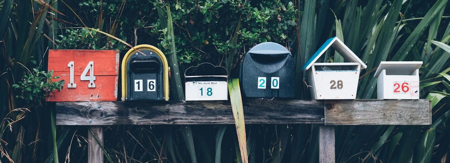 six assorted-color mail boxes