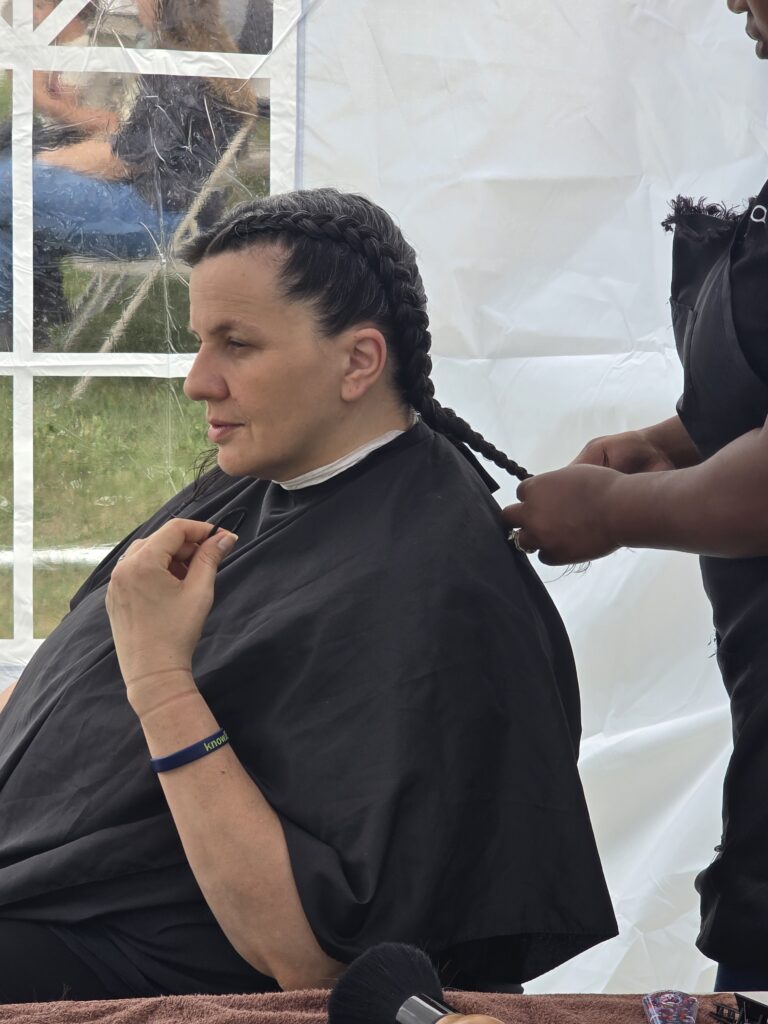 Close-up of finished braid hairstyle at outreach event