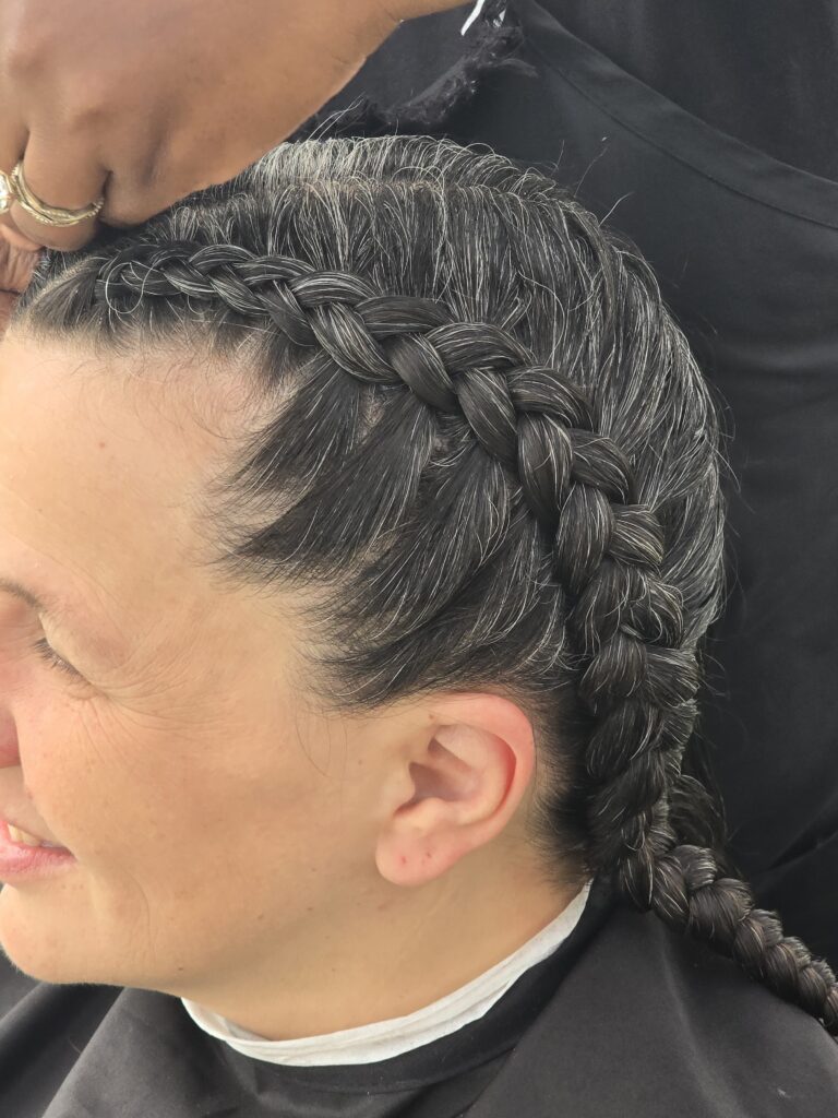 Close-up of finished braid hairstyle at outreach event