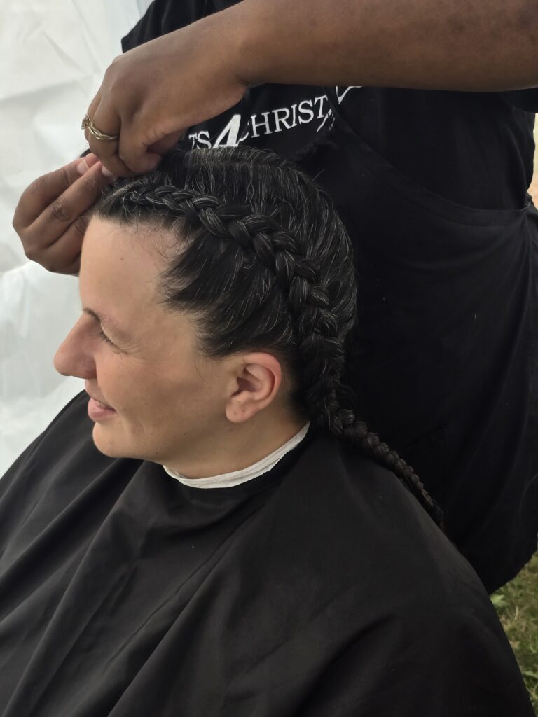 Close-up of finished braid hairstyle at outreach event