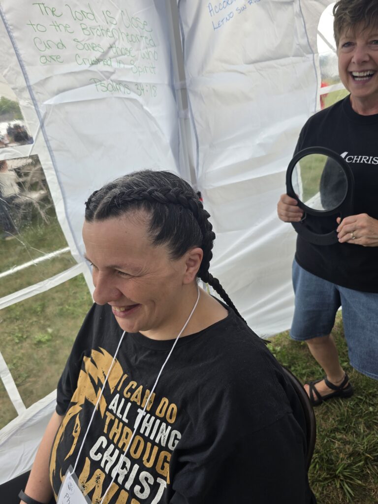 Close-up of finished braid hairstyle at outreach event