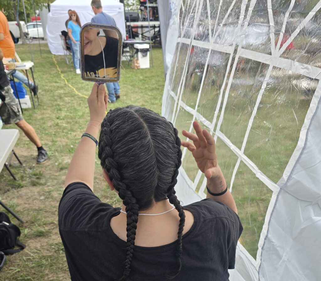 Close-up of finished braid hairstyle at outreach event