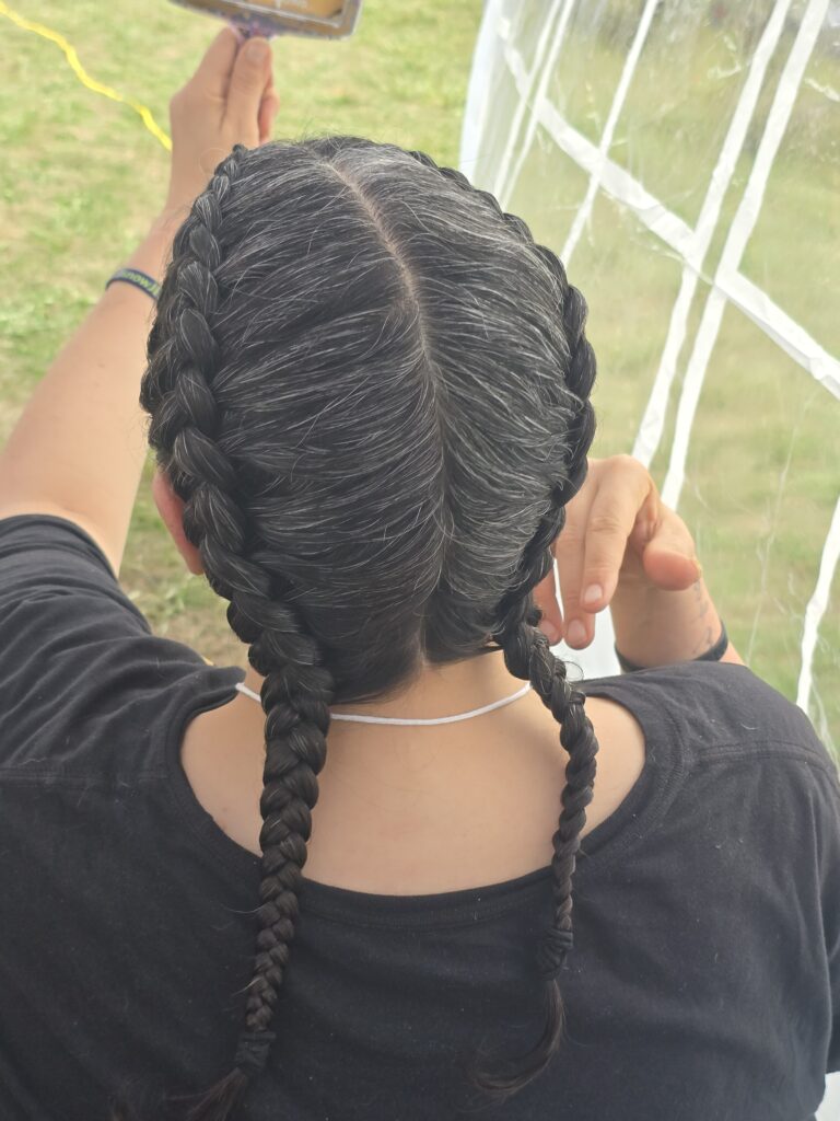 Close-up of finished braid hairstyle at outreach event