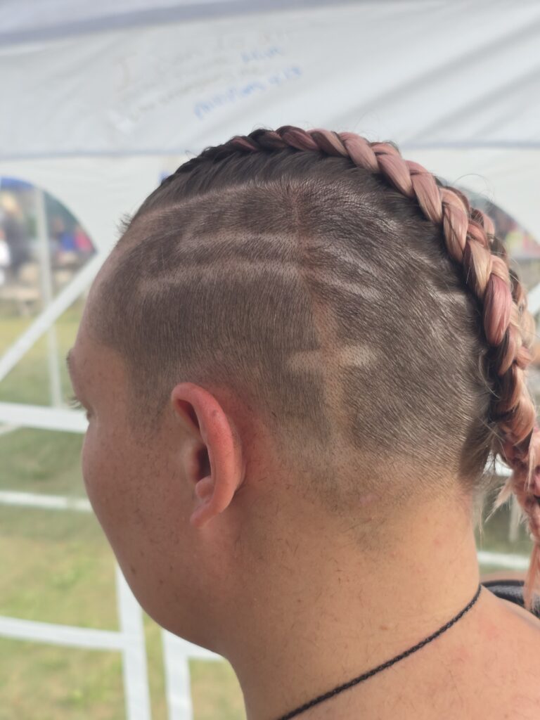 Crossfade braid haircut with shaved cross at Day of Joy outreach event