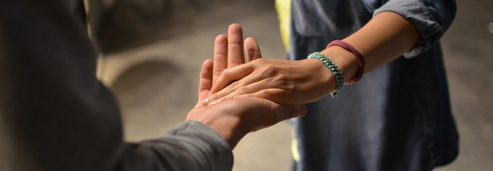 man and woman holding hands on street